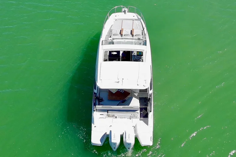 Slide: The Image of Aerial view of 2024 Beneteau Gran Turismo 32 yacht on green water. - 29