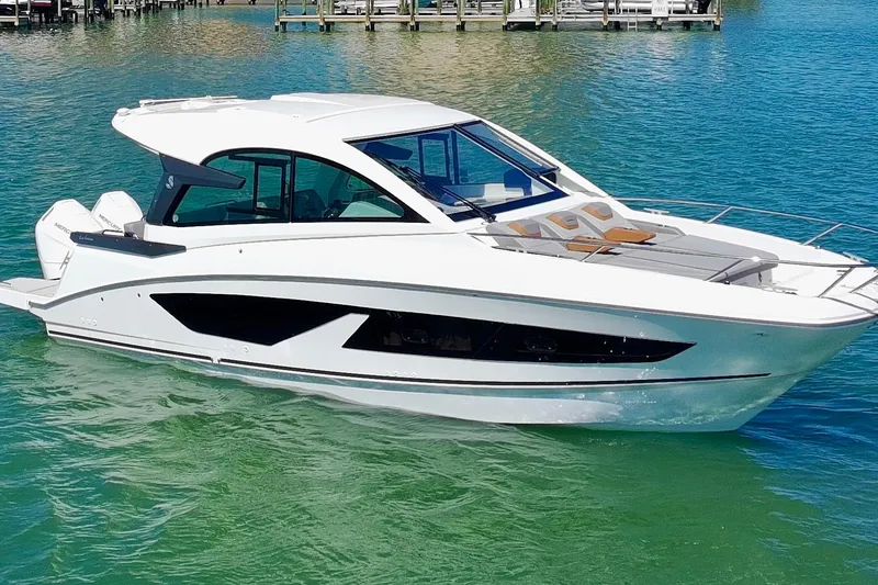 Slide: The Image of 2024 Beneteau Gran Turismo 32 yacht on clear blue water. - 3