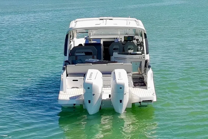 Slide: The Image of 2024 Beneteau Gran Turismo 32 yacht on clear turquoise water, rear view. - 32