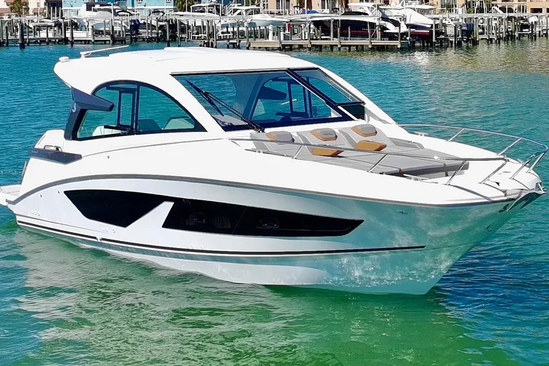 Slide: The Image of 2024 Beneteau Gran Turismo 32 yacht on clear turquoise water, showcasing sleek design. - 34