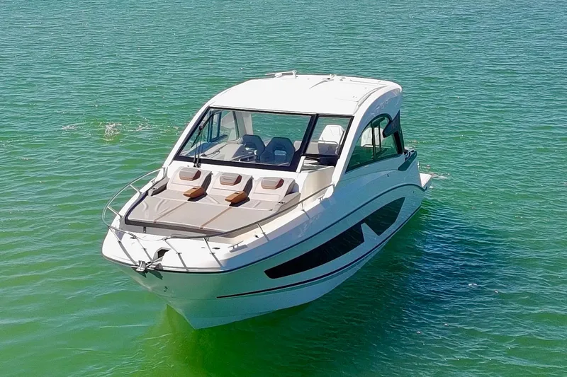 Slide: The Image of 2024 Beneteau Gran Turismo 32 yacht on calm green water. - 4