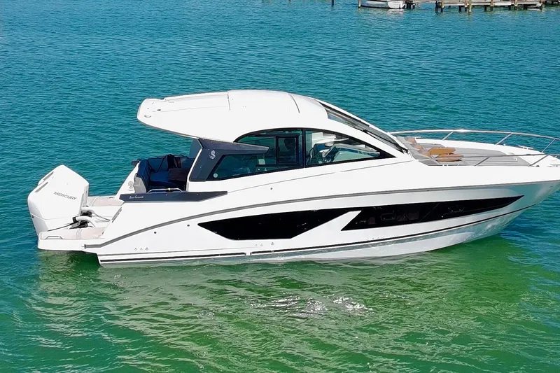 Slide: The Image of 2024 Beneteau Gran Turismo 32 yacht on clear turquoise water. - 5