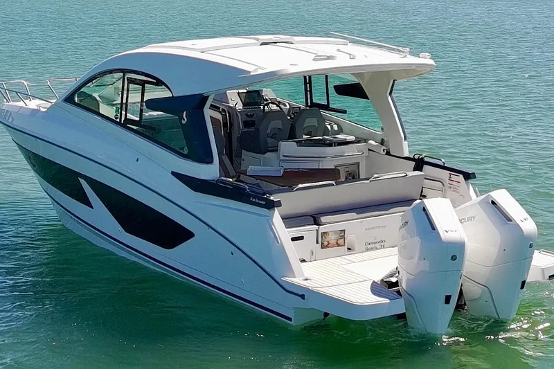 Slide: The Image of 2024 Beneteau Gran Turismo 32 yacht on water, showcasing sleek design and twin outboard engines. - 6