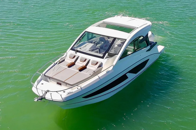 Slide: The Image of 2024 Beneteau Gran Turismo 32 yacht cruising on vibrant green water. - 7