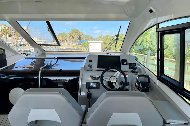 Slide: The Image of Interior cockpit of 2024 Beneteau Gran Turismo 32 yacht with modern controls and seating. - 9