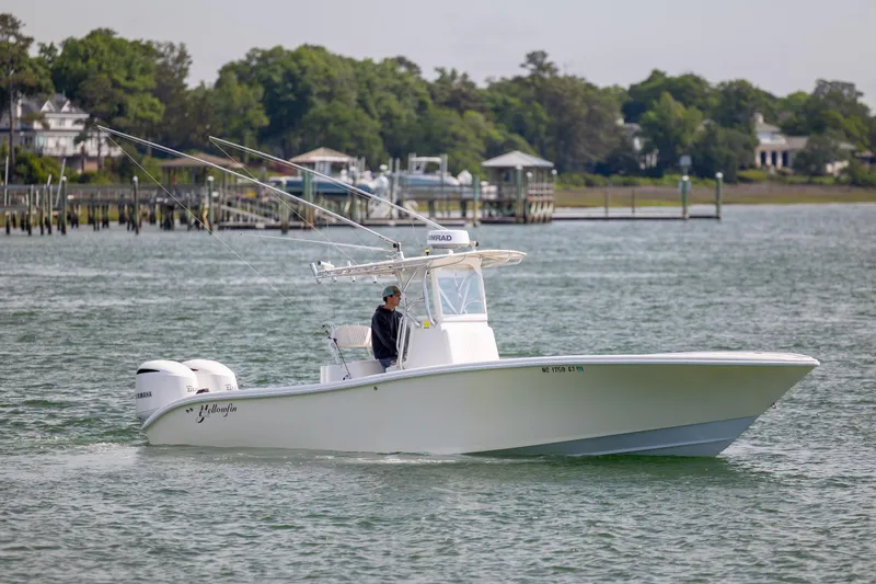 The Image of 2002 Yellowfin 31 Center Console boat cruising on a calm waterway. - 0