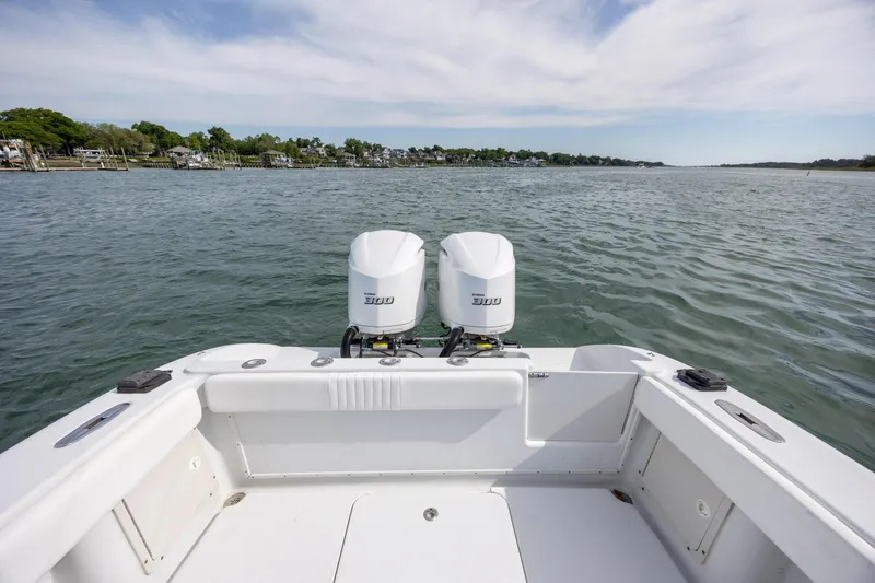 Slide: The Image of 2002 Yellowfin 31 Center Console boat with dual outboard engines on calm water. - 10