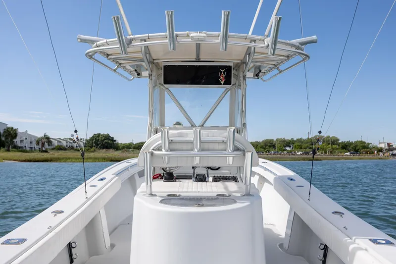 Slide: The Image of 2002 Yellowfin 31 Center Console boat on water, clear sky, shoreline in background. - 14