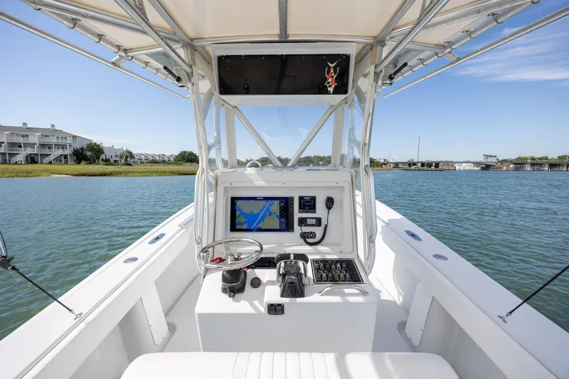 Slide: The Image of 2002 Yellowfin 31 Center Console boat interior with navigation system on calm water. - 15