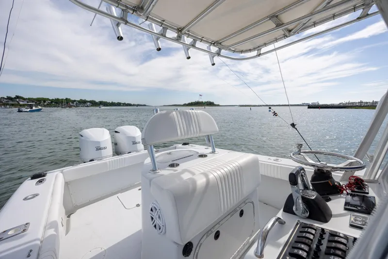 Slide: The Image of 2002 Yellowfin 31 Center Console boat on calm water, featuring dual engines and fishing gear. - 19