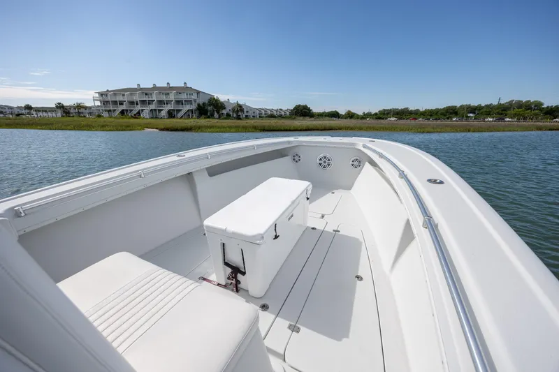 Slide: The Image of 2002 Yellowfin 31 Center Console boat on calm water near shoreline. - 20