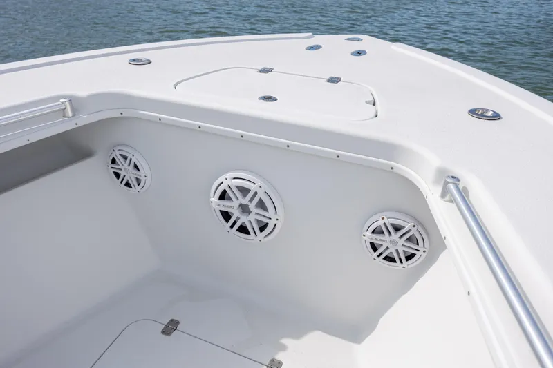 Slide: The Image of 2002 Yellowfin 31 Center Console boat interior with speakers, on calm water. - 22