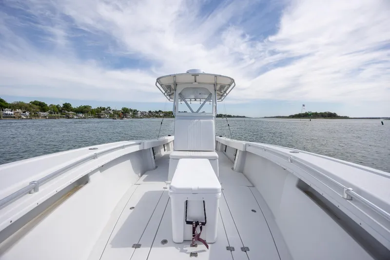 Slide: The Image of 2002 Yellowfin 31 Center Console boat on calm water under a partly cloudy sky. - 23