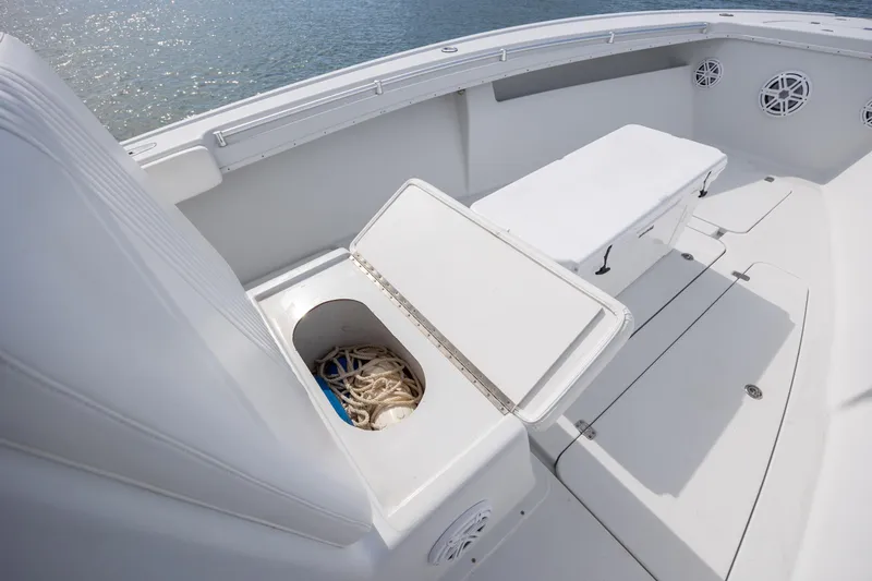 Slide: The Image of 2002 Yellowfin 31 Center Console boat interior with open storage compartment and seating. - 25