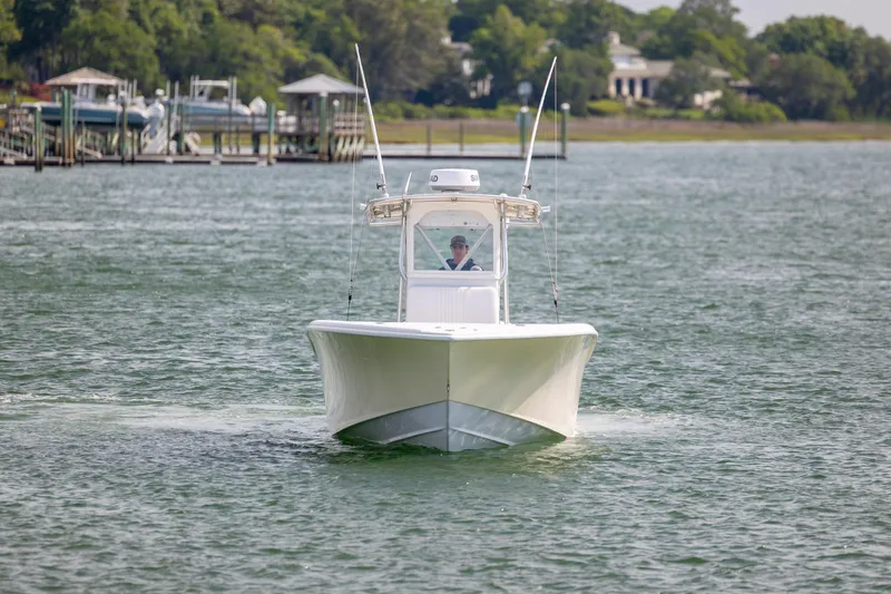 Slide: The Image of 2002 Yellowfin 31 Center Console boat cruising on a calm lake. - 3