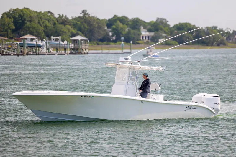 Slide: The Image of 2002 Yellowfin 31 Center Console boat cruising on a calm waterway. - 5