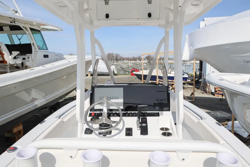 Slide: The Image of 2026 Sea Hunt Ultra 219 boat dashboard with steering wheel and Garmin navigation system. - 10