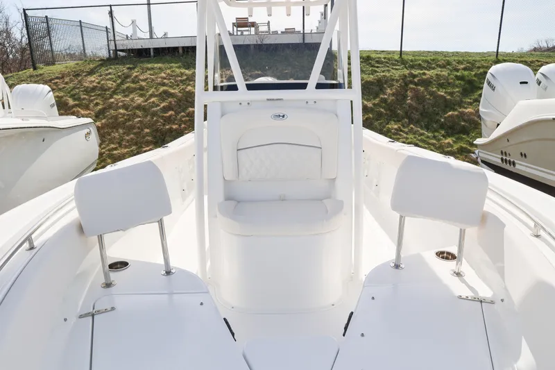 Slide: The Image of 2026 Sea Hunt Ultra 219 boat interior with white seating and sleek design. - 12