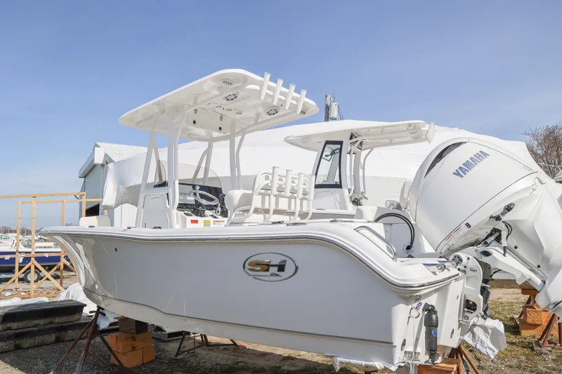 The Image of 2026 Sea Hunt Ultra 219 boat with Yamaha engine, displayed outdoors. - 2