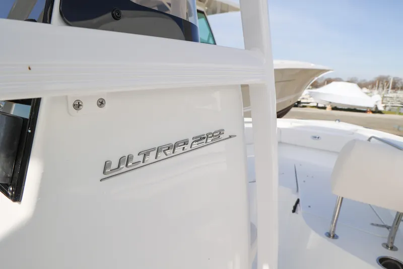 Slide: The Image of 2026 Sea Hunt Ultra 219 boat, close-up of model name on white exterior. - 4