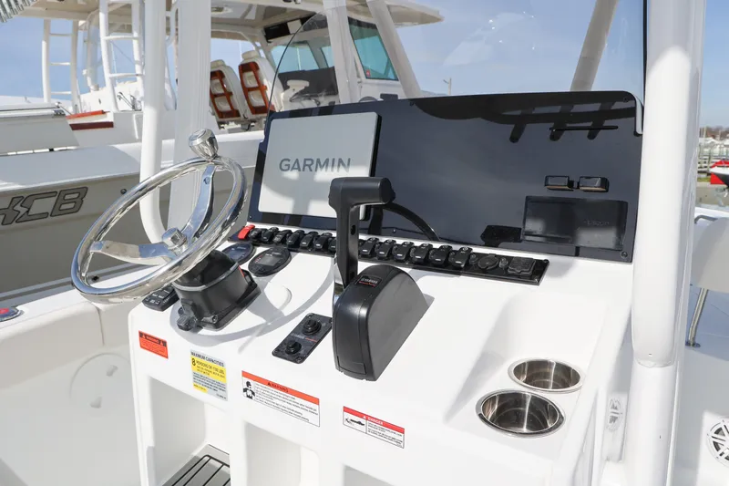Slide: The Image of 2026 Sea Hunt Ultra 219 boat dashboard with Garmin navigation system and steering wheel. - 5
