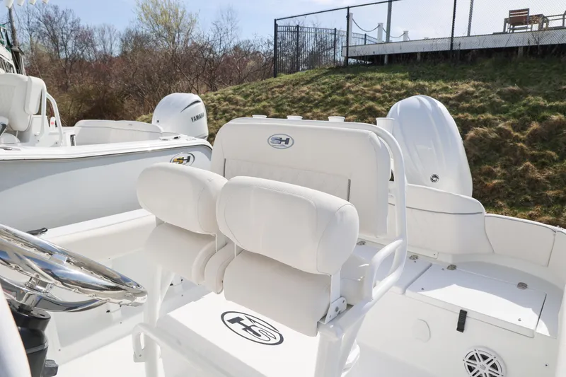 Slide: The Image of 2026 Sea Hunt Ultra 219 boat interior with white seating and Yamaha engine. - 8