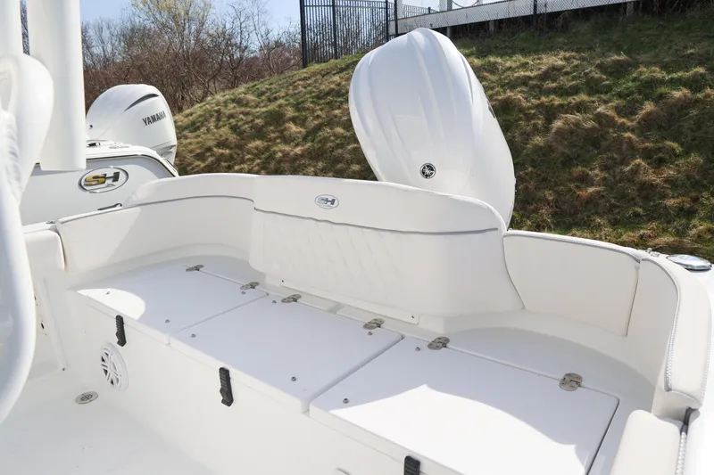 Slide: The Image of 2026 Sea Hunt Ultra 219 boat interior with Yamaha engine, featuring white seating and storage compartments. - 9