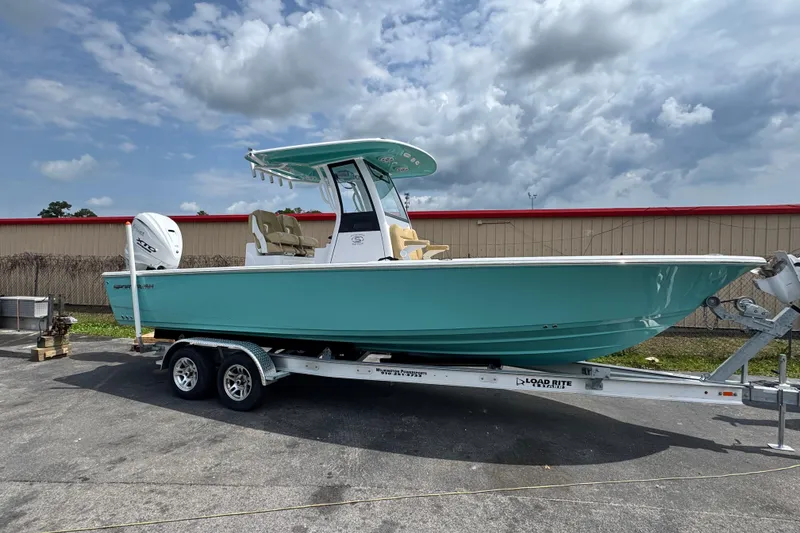 The Image of 2024 Sportsman Masters 267 Bay Boat on trailer under cloudy sky. - 10