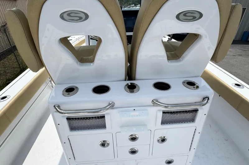 Slide: The Image of 2024 Sportsman Masters 267 Bay Boat interior with dual seats and storage compartments. - 12