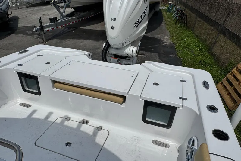 Slide: The Image of 2024 Sportsman Masters 267 Bay Boat with powerful V8 engine, docked outdoors. - 16