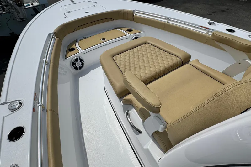 Slide: The Image of 2024 Sportsman Masters 267 Bay Boat interior with tan seating and sleek design. - 17