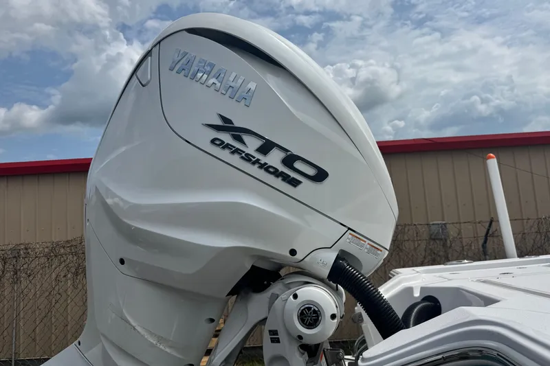 Slide: The Image of Yamaha XTO Offshore engine on 2024 Sportsman Masters 267 Bay Boat under cloudy sky. - 22