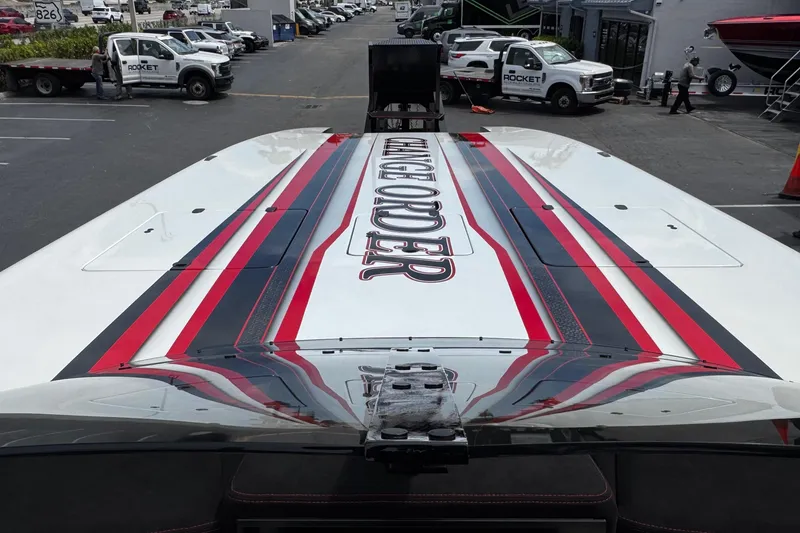 Slide: The Image of 2025 Performance Powerboats P420 with bold red and black stripes on deck. - 13