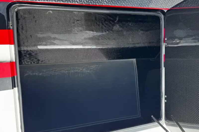 Slide: The Image of Open storage compartment of 2025 Performance Powerboats P420, featuring sleek carbon fiber design. - 18