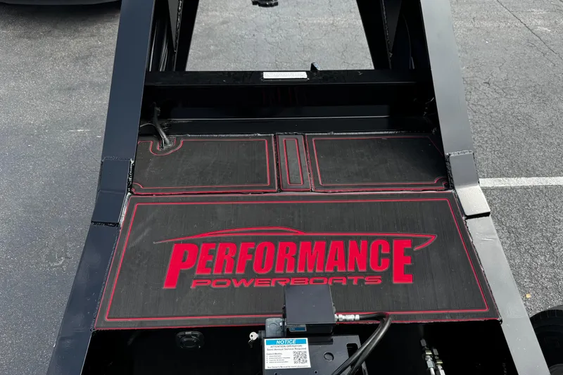 Slide: The Image of 2025 Performance Powerboats P420 trailer with logo, black and red design, parked on asphalt. - 29