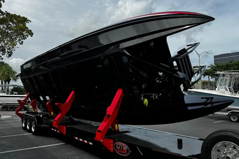 Slide: The Image of 2025 Performance Powerboats P420 on a trailer, showcasing sleek black hull design. - 34