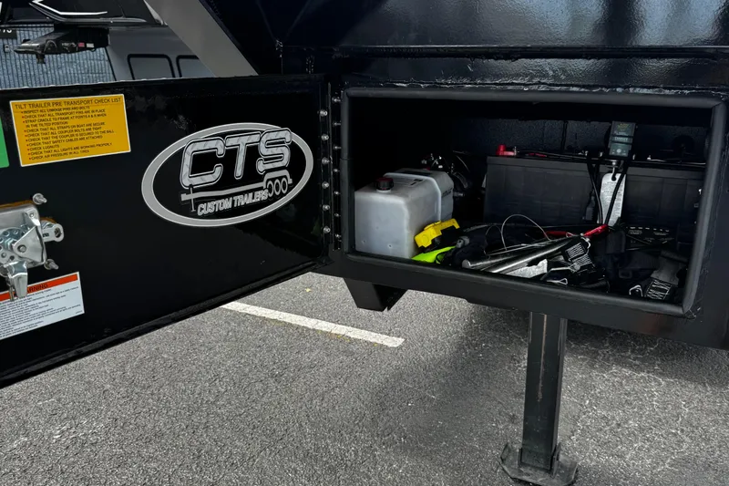 Slide: The Image of Open storage compartment of a 2025 Performance Powerboats P420 trailer with tools and equipment. - 36