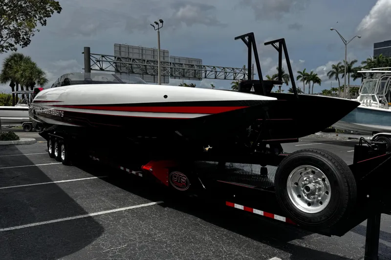 Slide: The Image of 2025 Performance Powerboats P420 on trailer, sleek design, parked outdoors under cloudy sky. - 4