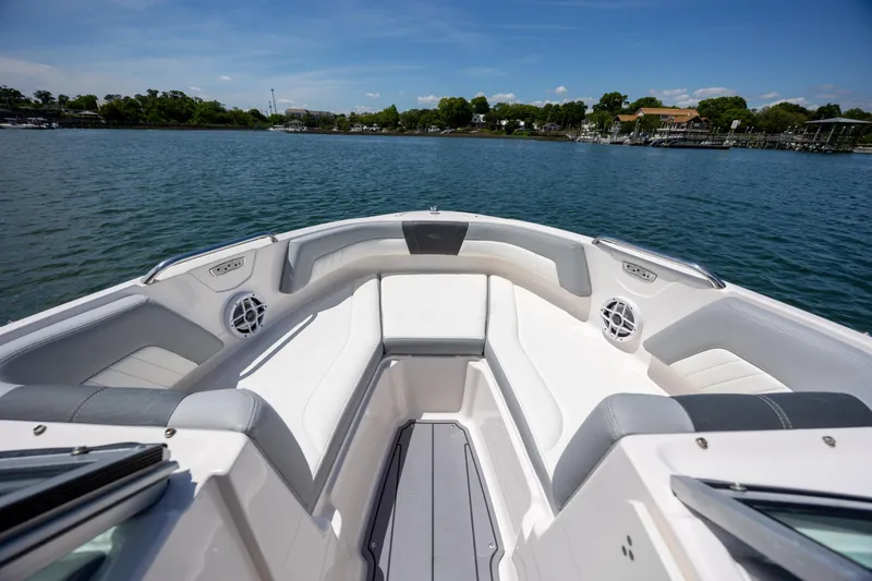 Slide: The Image of 2023 Chaparral 21 SSi boat interior with spacious seating on a serene lake. - 11