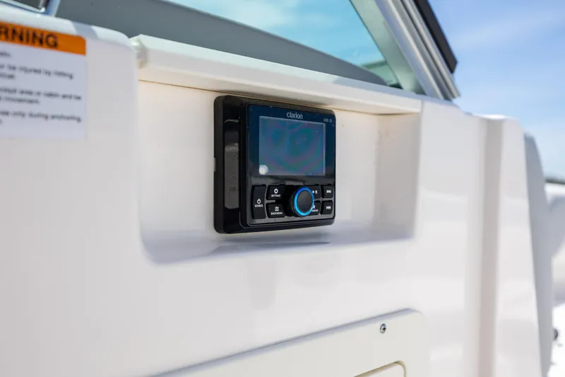Slide: The Image of 2023 Chaparral 21 SSi boat dashboard with Clarion audio system. - 12