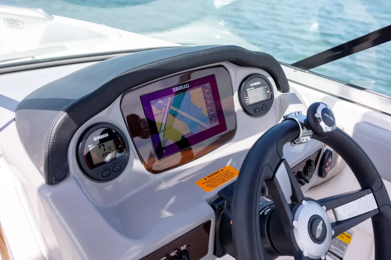 Slide: The Image of 2023 Chaparral 21 SSi boat dashboard with Simrad display and Yamaha gauges. - 16