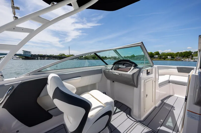 Slide: The Image of 2023 Chaparral 21 SSi boat interior with sleek design and waterfront view. - 19