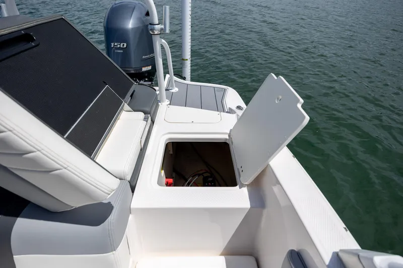 Slide: The Image of 2023 Chaparral 21 SSi boat with open storage compartment and Yamaha 150 engine. - 8