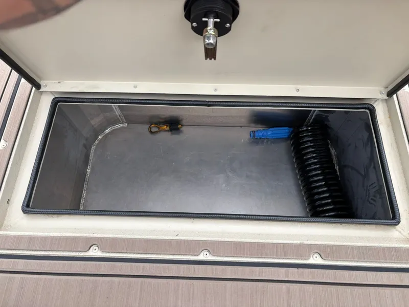 Slide: The Image of Interior of SeaArk Easy Cat 2026 with storage compartment and accessories. - 12