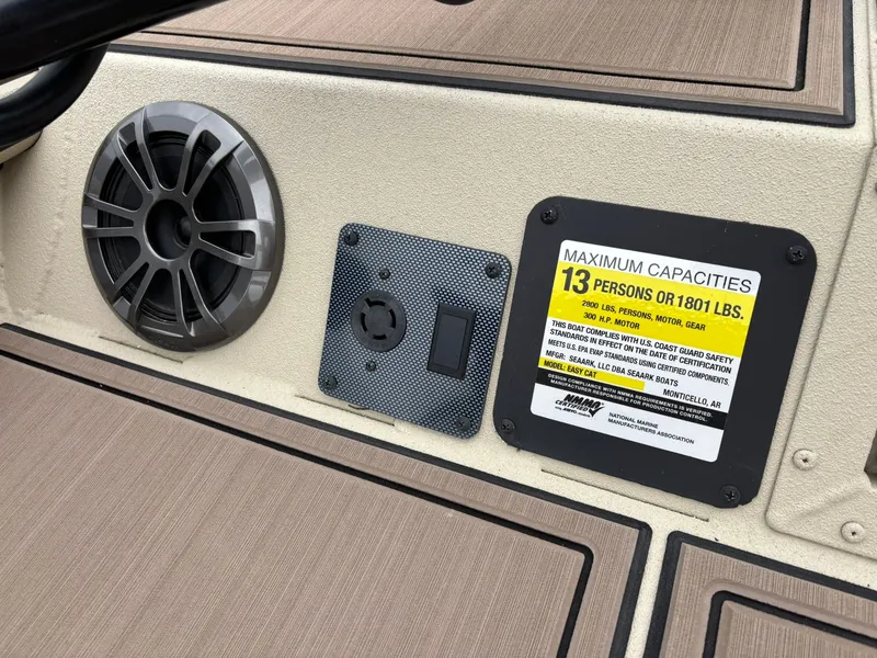 Slide: The Image of SeaArk Easy Cat 2026 boat capacity label and speaker. - 14