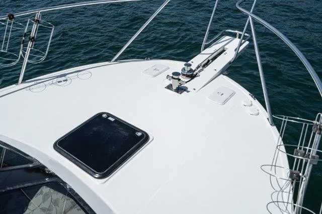 Slide: The Image of 2011 Skipjack 300 Flybridge boat deck with hatch, railing, and ocean view. - 20