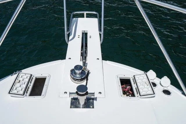 Slide: The Image of Bow view of 2011 Skipjack 300 Flybridge boat with anchor and storage compartments. - 21