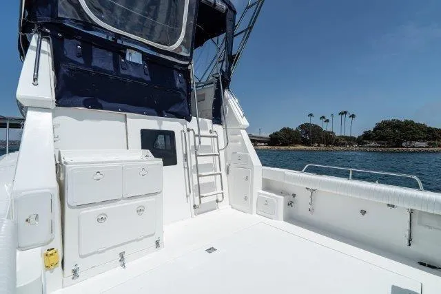 Slide: The Image of 2011 Skipjack 300 Flybridge boat deck with storage, ladder, and ocean view. - 27