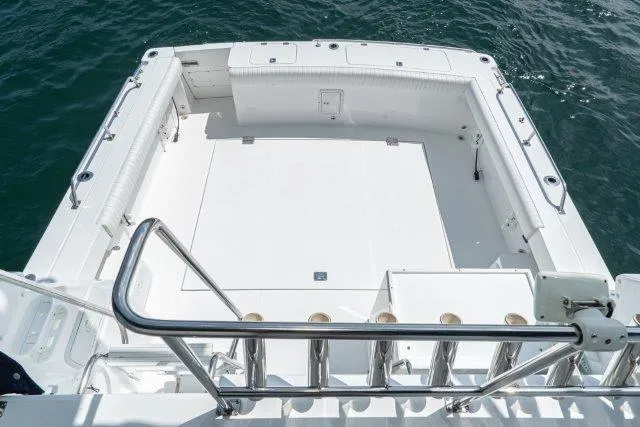 Slide: The Image of 2011 Skipjack 300 Flybridge boat deck with stainless steel railings on open water. - 29