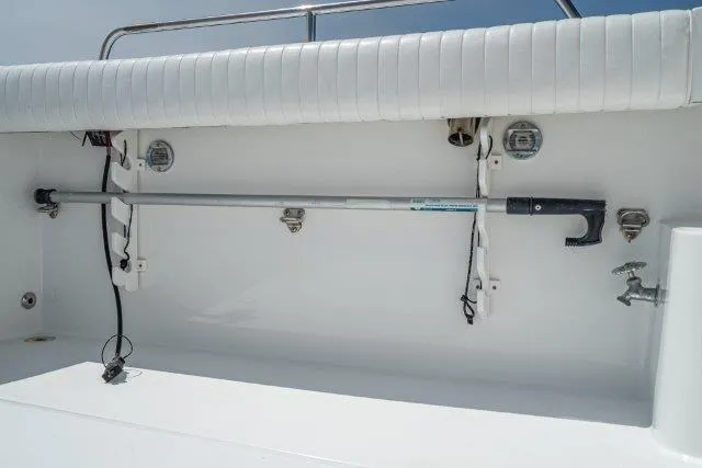 Slide: The Image of 2011 Skipjack 300 Flybridge boat interior with rod holder and white seating. - 34